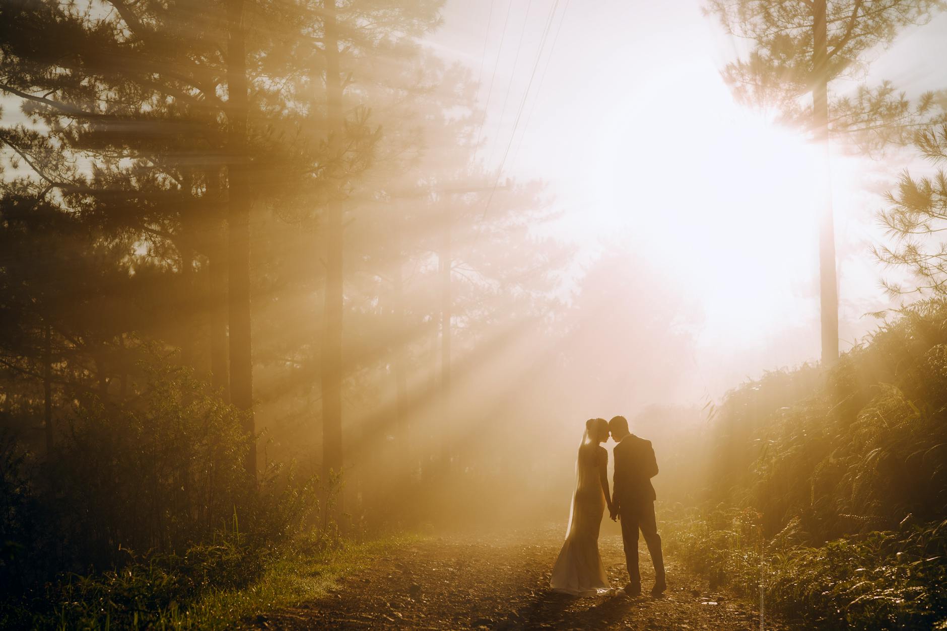 unrecognizable newlywed couple in forest