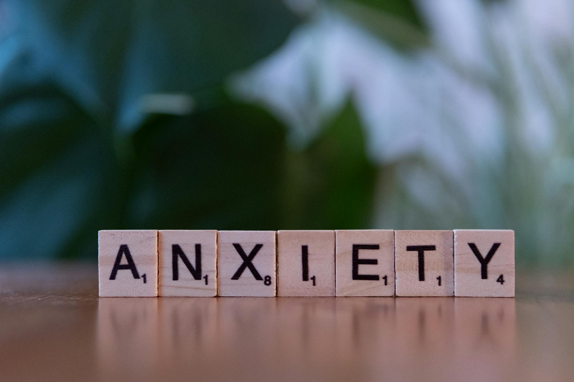 wooden blocks spelling anxiety on wooden surface